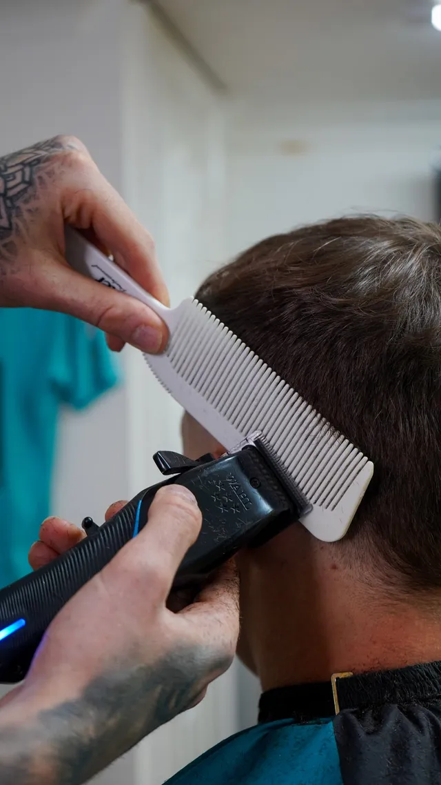 Detail of a fresh fade being finished with a comb